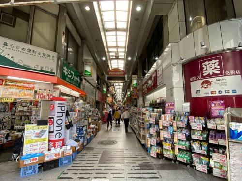 a store aisle of a store with people walking through it at 1min walk to sta, drct bus to HND! Easy access! 03 in Tokyo
