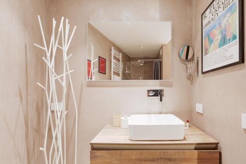 a bathroom with a white sink and a mirror at Chic & Modern Flat just 450 mt from Centrale FS in Milan