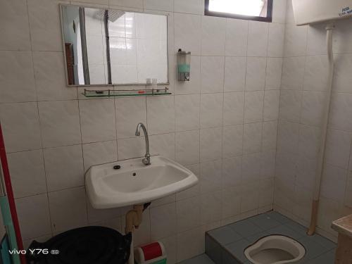a bathroom with a sink and a toilet at De' Aman Homestay in Jitra