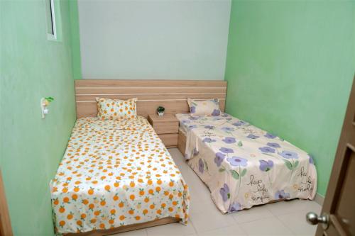 a bedroom with two beds in a room at Lucky Home in Nha Trang