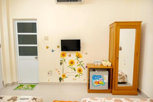 a room with a wall with sunflowers on it at Lucky Home in Nha Trang