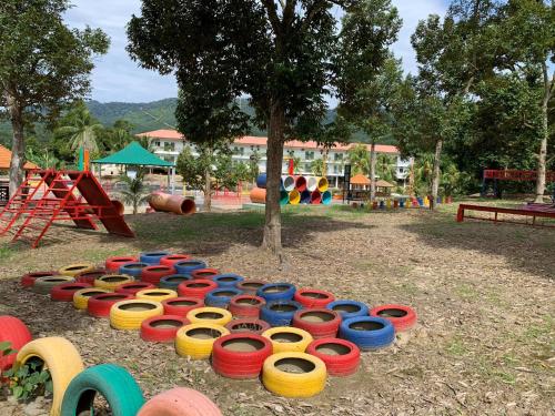 a row of colorful tires in a playground at LiLLA Summer Retreat - Bentong in Kampung Sunjai Gapoi
