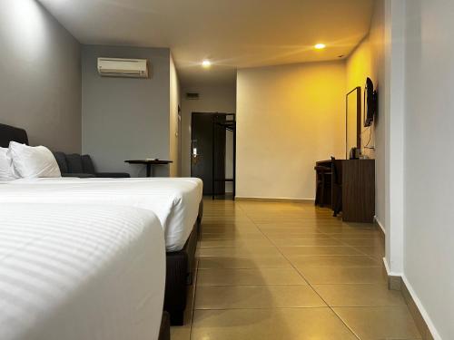 a hotel room with two beds and a hallway at SiN LiEN HOTEL in Kluang