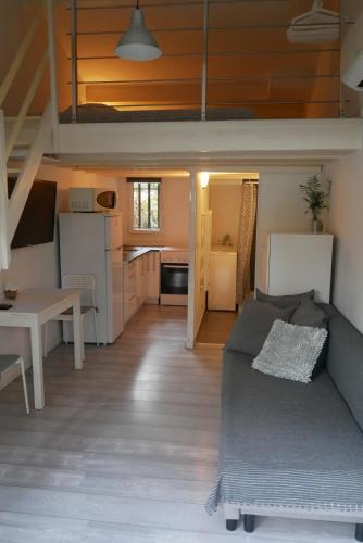 a living room with a bed and a kitchen at Studio du Pouverel in La Garde