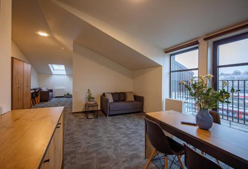 a large living room with a couch and a table at Loft Inn SELF-CHECK IN in Vilnius