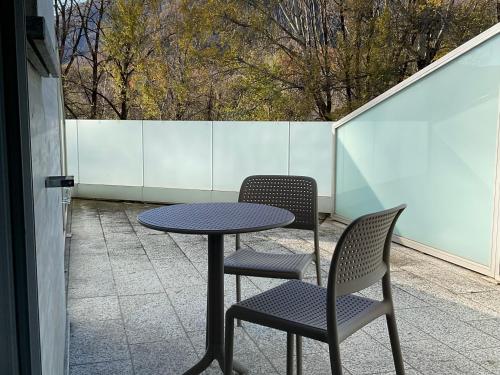 a table and two chairs on a patio at Hotel Liberty Self Check-In in Bellinzona