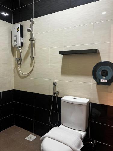 a bathroom with a shower and a white toilet at SiN LiEN HOTEL in Kluang