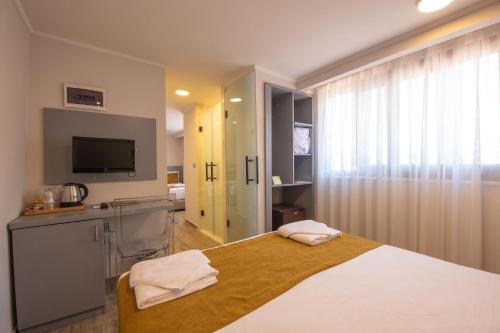 a bedroom with a bed and a television in a room at Orka World Hotel & Aquapark in Oludeniz