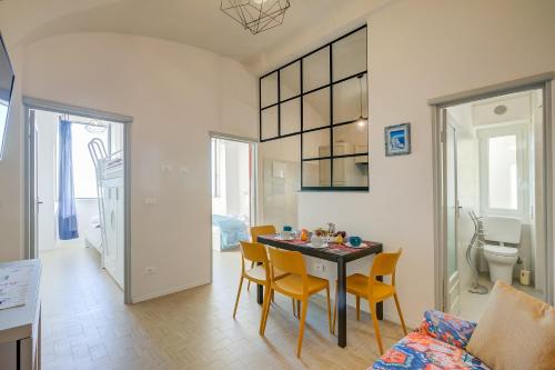a kitchen and dining room with a table and chairs at La Casa Sulla Spiaggia - On The Beach- Happy Rentals in Alassio