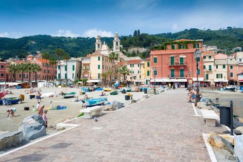 a group of people on a beach in a town at La Casa Sulla Spiaggia - On The Beach- Happy Rentals in Alassio