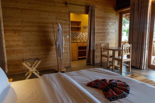 a bedroom with a bed and a table in a room at Umutuzo lodge Kivu lake 