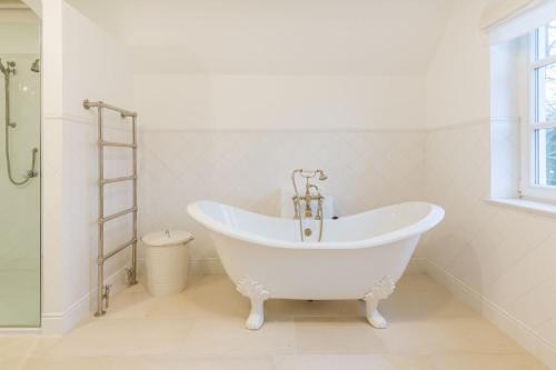 a white bath tub in a bathroom with a ladder at Landhaus Brook in Brook