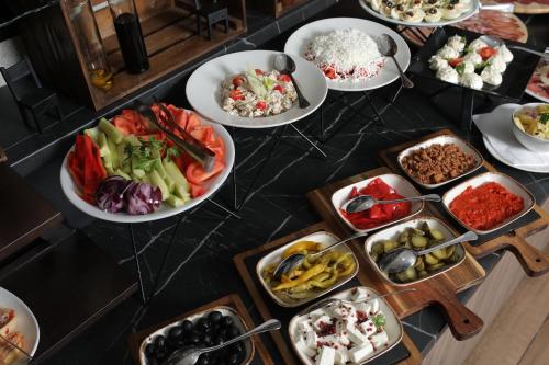 a buffet with plates of food on a table at Nobel Gallery Hotel in Belgrade