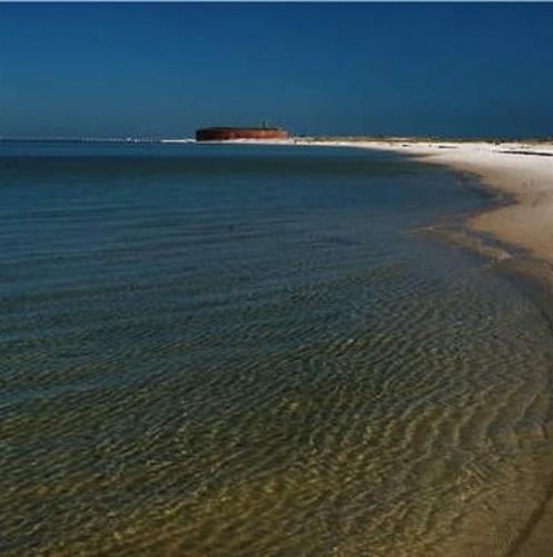 a large body of water with a sandy beach at Holiday Inn Express - Gulfport Beach by IHG in Gulfport