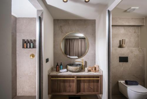 ein Bad mit einem Waschbecken und einem Spiegel in der Unterkunft Elounda Infinity Exclusive Resort & Spa - Adults Only in Elounda