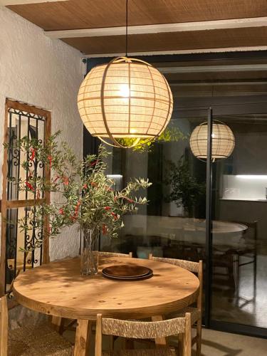 a dining room table with two lights and a table with chairs at Bond beach village in Altafulla