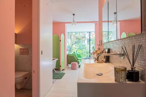 a bathroom with a sink and a toilet at Stylish Garden-Gem by Lake: Pet-Friendly & Central in Zürich