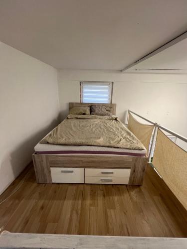 a bed in a small room with a window at Apartma Lilijana in Ljubljana