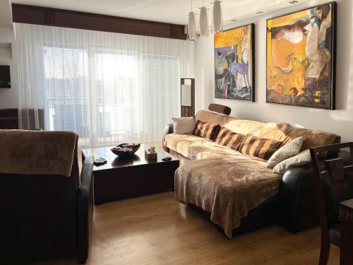 a living room with a couch and a table at Lux Apartmán Centrum in Topoľčany
