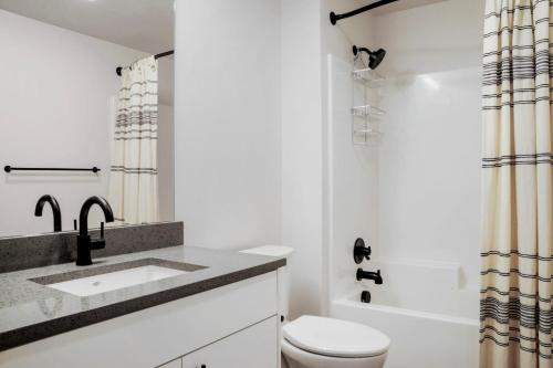 a bathroom with a sink and a toilet and a shower at Lower Queen Anne 1br w game room garden SEA-698 in Seattle