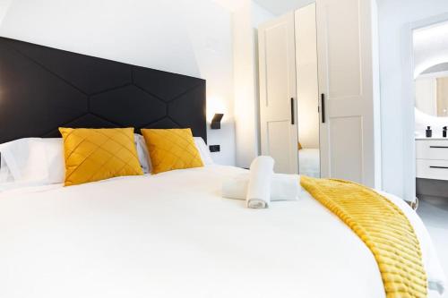 a bedroom with a large white bed with yellow pillows at Loft 11 B in Murcia