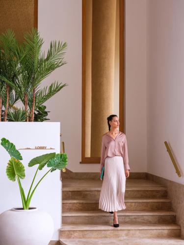 a woman walking down the stairs in a building at The View Agadir in Agadir