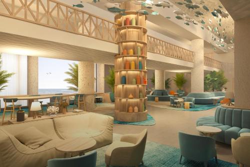 a lobby with couches and chairs and a tower at The View Agadir in Agadir
