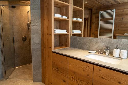 a bathroom with a sink and a shower at Agriturismo La Stalla in Bormio