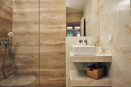 a bathroom with a sink and a shower at Thelxi's Suite II - Brand New Seaview Suite! in Volímai