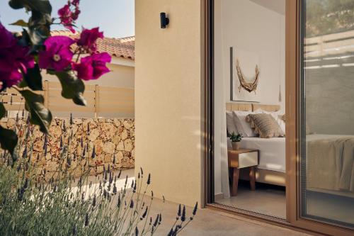 a mirror in front of a room with a bed at Thelxi's Suite II - Brand New Seaview Suite! in Volimes