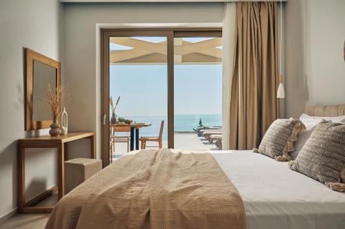 a bedroom with a bed and a view of the ocean at Thelxi's Suite II - Brand New Seaview Suite! in Volímai