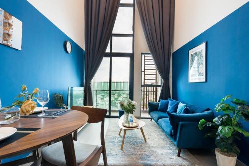 a living room with blue walls and a blue couch at DingD0ng Home FelizEnVista 5-star facilities in Ho Chi Minh City