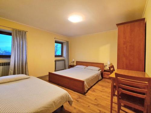 a bedroom with two beds and a window at Pansion Potok (kod Suzi) in Vrata