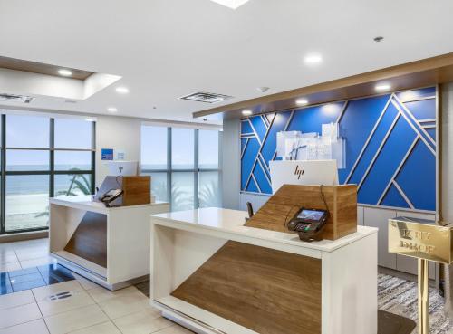 a store with blue walls and white counters in a room at Holiday Inn Express - Gulfport Beach by IHG in Gulfport