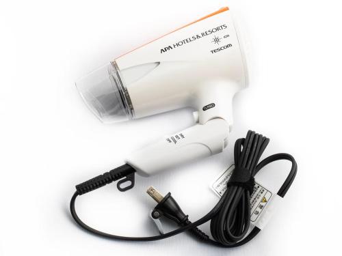 a white blow dryer with a black cord and a blow dryerimeter at APA Hotel TKP Tokyo Nishi-Kasai in Tokyo