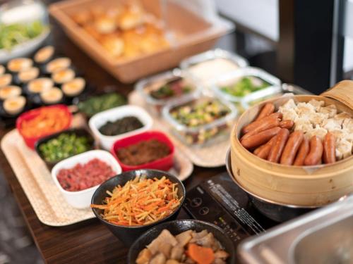 a table topped with bowls of different types of food at APA Hotel TKP Tokyo Nishi-Kasai in Tokyo