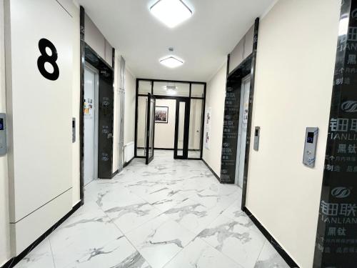 a corridor of an office building with marble flooring at Raisson Ahotel Grand Turan 32 in Astana
