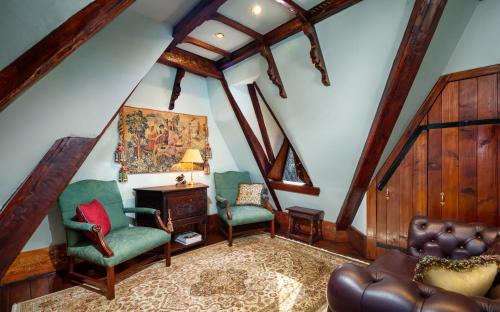 a living room with two chairs and a table at Thorngrove Manor in Stirling