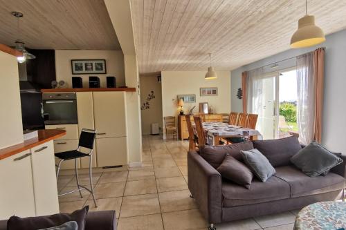 un salon avec un canapé et une table dans l'établissement Capucines et agapanthes, à Saint-Nic