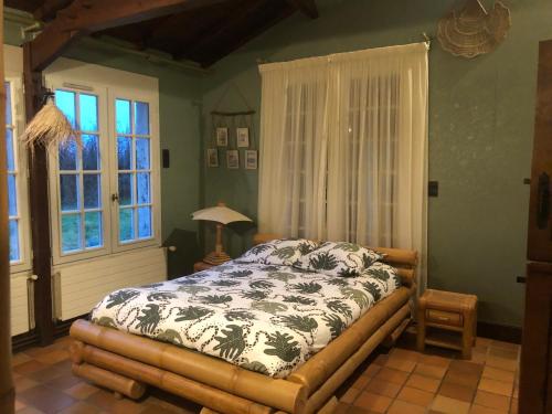 a bedroom with a bed and a window at Maison à 10 min du puy du fou et parc de Maulévrier in Saint-Amand-sur-Sèvre