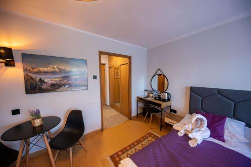 a bedroom with a bed with a stuffed animal on it at WRZOS resort & wellness in Węgierska Górka