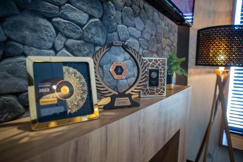 a trophy on a counter with a stone wall at WRZOS resort & wellness in Węgierska Górka