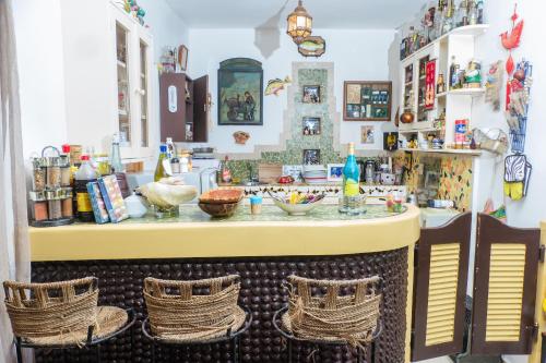 a bar in a room with wicker chairs at Fabuleuse Villa Keur Bibou in Dakar