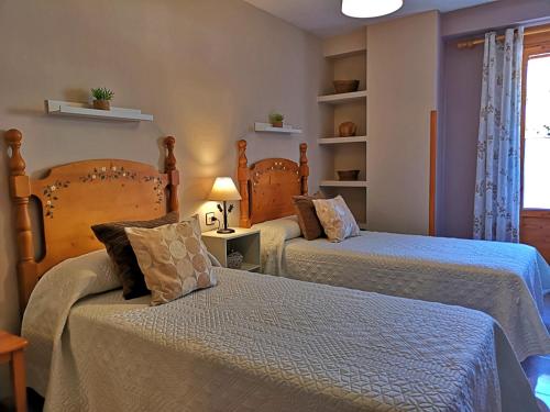 a bedroom with two beds and a window at Alojamiento Martinez 1 in Cazorla