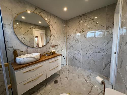 a bathroom with a sink and a mirror at luxury golden sunset apartment Aloha puerto banus in Marbella