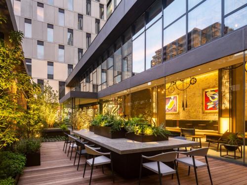 a patio with tables and chairs and a building at Tokyo Bay Shiomi Prince Hotel in Tokyo
