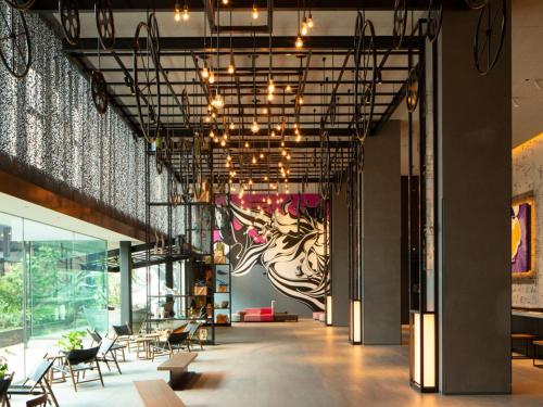 a lobby of a building with tables and chairs at Tokyo Bay Shiomi Prince Hotel in Tokyo