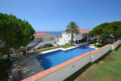a swimming pool on the side of a house at Viva Sitges - Sitges View in Sitges