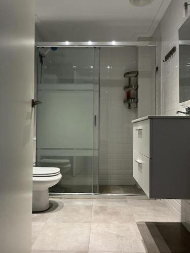 a bathroom with a glass shower and a toilet at La morada de Crevillent in Crevillente