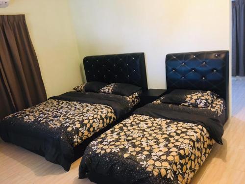 a room with two beds and a head board at Lang Buana Eco Park in Jerantut